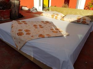a bed with a white comforter and pillows at sobe za odmor in Petrovaradin
