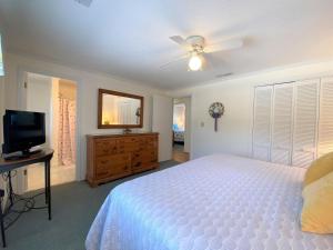 a bedroom with a bed and a flat screen tv at Dreamcatcher in Edisto Island