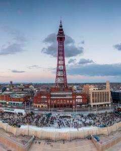 a crowd of people in front of the eiffel tower at Reads Avenue - Luxury Ground Floor Studio - Next Door to H&A Social Club in Blackpool