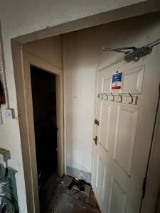 a room with a white door and a wall with signs on it at Reads Avenue - Luxury Ground Floor Studio - Next Door to H&A Social Club in Blackpool