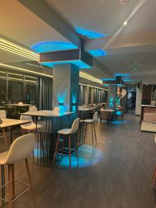 a restaurant with blue lights on the ceiling at Pekini Plaza Onix in Tbilisi City