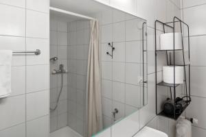 a bathroom with a shower with a glass door at Studio 2 pp - Crans-Montana Centre - Rue du Prado in Lens
