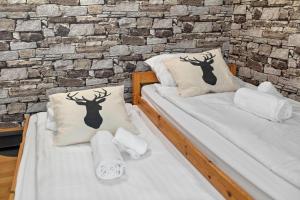 two beds in a room with a brick wall at Studio 2 pp - Crans-Montana Centre - Rue du Prado in Lens