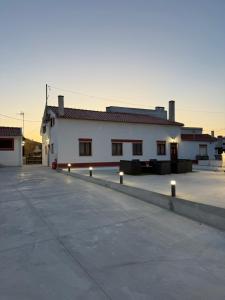 a large white building with lights in a parking lot at Blend-Inn Summer House in São Martinho do Porto