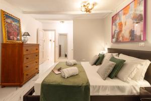 ein Schlafzimmer mit einem großen Bett und einer Kommode in der Unterkunft Crispi 30 Stylish Apartment in Rom