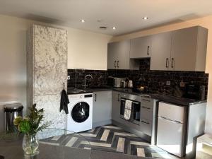 a kitchen with a washer and dryer at Lux Style Homes in Peterborough