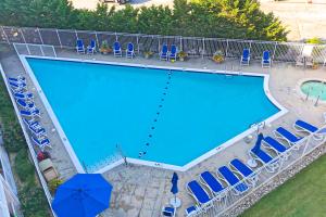 an overhead view of a swimming pool with chairs and an umbrella at Triton's Trumpet B 303 in Ocean City