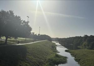 a river in a field next to a road at 10 Minutes from Universal - Relaxing Guest Suite in Orlando +12 photos