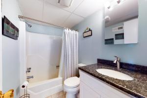 a bathroom with a sink and a toilet and a tub at Pelican Beach 304 in Ocean City +16 photos
