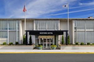 a front view of a hotel with an american flag at Midtown Hotel in Boston