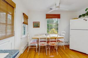 a kitchen with a table and a refrigerator at Cozy Corner in Edgartown +12 photos