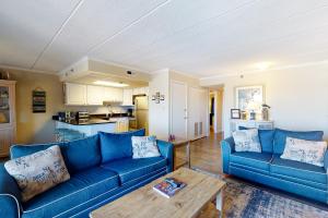 a living room with two blue couches and a table at White Marlin 307B in Ocean City