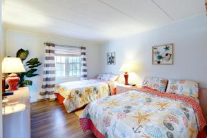 a bedroom with two beds and a window at White Marlin 307B in Ocean City +18 photos