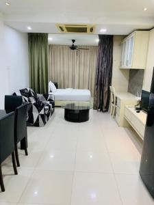 a living room with a couch and a table at Tarragon Family Suite Apartment in Kuala Lumpur