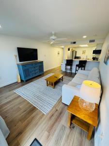 a living room with a couch and a tv at Relax Inn-Seamist 156 in Port Aransas