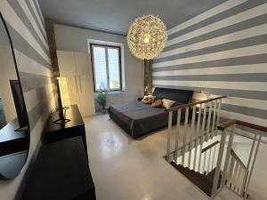 a living room with a bed and a chandelier at The Loft in Pisa +11 photos