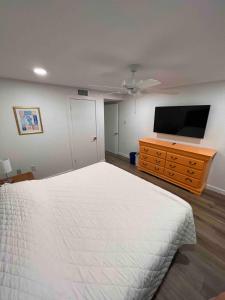 a bedroom with a bed and a flat screen tv at Relax Inn-Seamist 156 in Port Aransas +9 photos