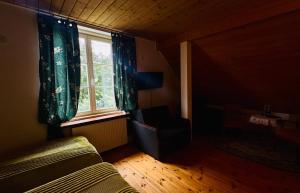 a bedroom with a bed and a window at Dwór Strzyżew in Żelazowa Wola