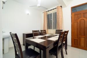 a dining room with a table and chairs at Marhaba Tausi Nyali in Mombasa