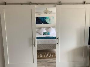 a closet with a door open to a beach room at Chic Maui Condo Steps From Beach & Ocean in Wailea +52 photos