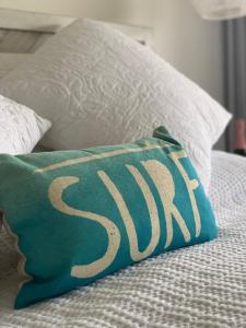 a pillow with the word spa is sitting on a bed at Chic Maui Condo Steps From Beach & Ocean in Wailea