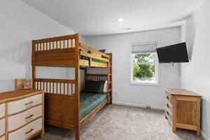 a bedroom with a bunk bed and a desk and a television at Whaley Good Livin in Bogue