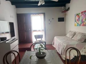 a bedroom with a bed and a table and chairs at La Casita in Neuquén