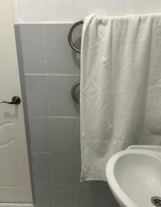 a bathroom with a sink and a white towel at Minimalist 2-room Apartment in Aktobe +12 photos