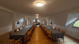 a row of tables and chairs in a room at Dwór Strzyżew in Żelazowa Wola