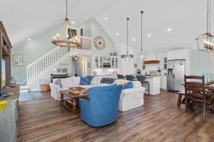 a living room with a couch and a table at Sweet Dreams Beach House in Emerald Isle