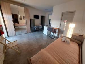 a bedroom with a bed and a living room at La dimora del viaggiatore in Gallarate