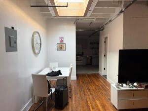 a room with a table and a flat screen tv at ROOM IN WILLIAMBURG IN A 2BEDROOMS APt in Brooklyn