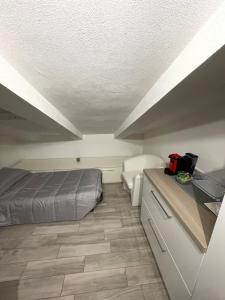 a bedroom with a bed and a desk in it at Lovely apartment near the beach in Follonica