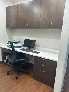 an office with a desk with a computer and a chair at Country Inn & Suites by Radisson, Concord (Kannapolis), NC in Concord