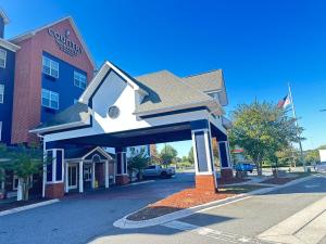 a house shaped building in front of a building at Country Inn & Suites by Radisson, Concord (Kannapolis), NC in Concord