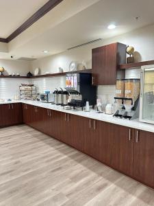 a large kitchen with wooden cabinets and a counter top at Country Inn & Suites by Radisson, Concord (Kannapolis), NC in Concord