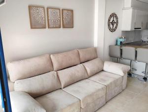 a living room with a couch and a kitchen at Dream apartment in Isla Plana in Mazarrón +3 photos