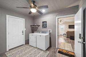 a laundry room with a washer and a ceiling fan at Baytown Getaway Patios BBQ Family-Friendly in Baytown +23 photos