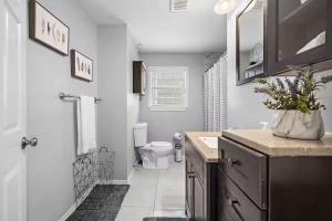 a bathroom with a sink and a toilet in it at Baytown Getaway Patios BBQ Family-Friendly in Baytown