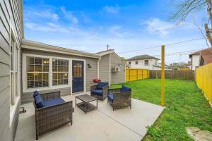 a patio with chairs and a table in a yard at Baytown Getaway Patios BBQ Family-Friendly in Baytown