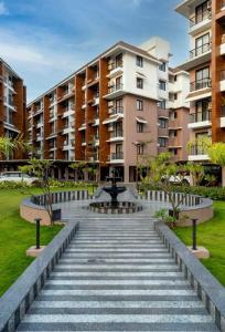 a walkway in front of some apartment buildings at Pillowtalk Apartment in Nerul