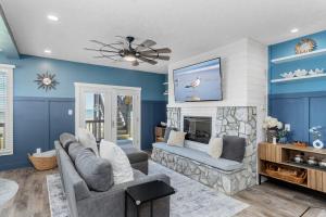 a living room with blue walls and a fireplace at Ocean Reef 4 A-1 in Emerald Isle