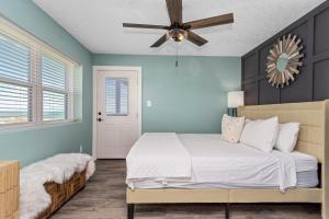 a bedroom with a bed and a ceiling fan at Ocean Reef 4 A-1 in Emerald Isle +41 photos
