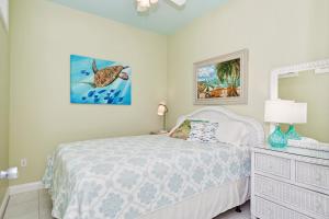 a bedroom with a bed and a dresser and a mirror at Ocean Club J-301 in Indian Beach +54 photos