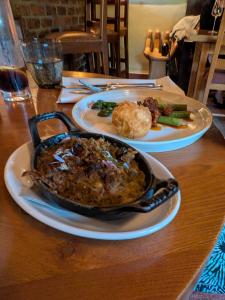 a table with two plates of food on a table at St Quintin Arms in Harpham