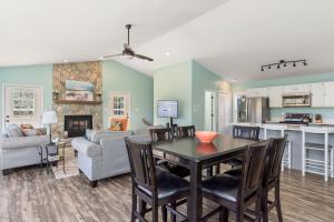 a dining room and living room with a table and chairs at Indigo Horizon in Bogue