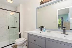 a bathroom with a toilet and a sink and a shower at Indigo Horizon in Bogue +38 photos