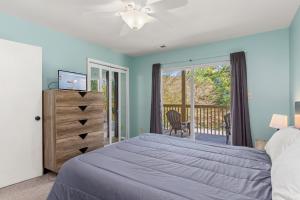 a bedroom with a bed and a balcony at Indigo Horizon in Bogue