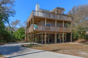 a house with a wrap around deck on a road at Indigo Horizon in Bogue