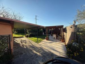 a house with a patio with a fence at Emily house in Casa Gherardi